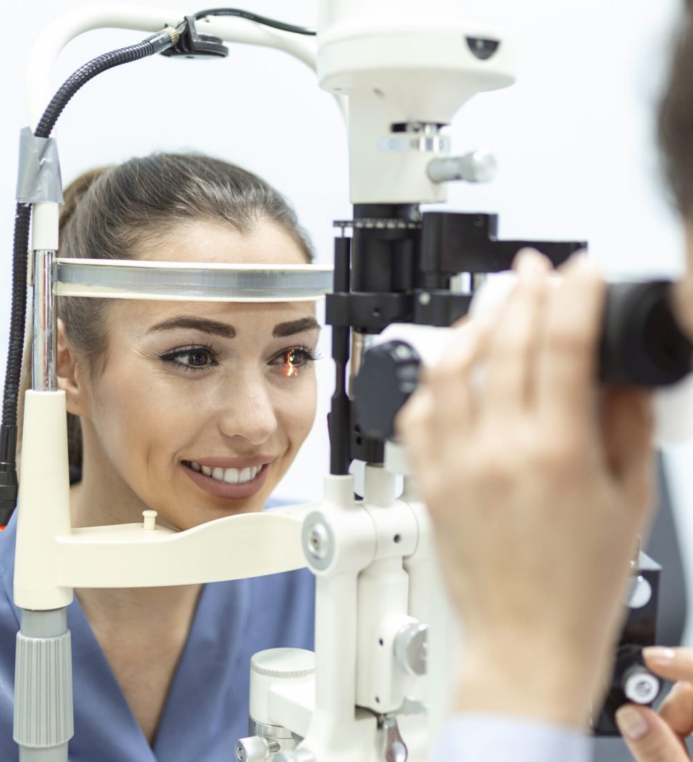 Eye doctor with female patient during an examination in modern clinic. Ophthalmologist is using special medical equipment for eye health